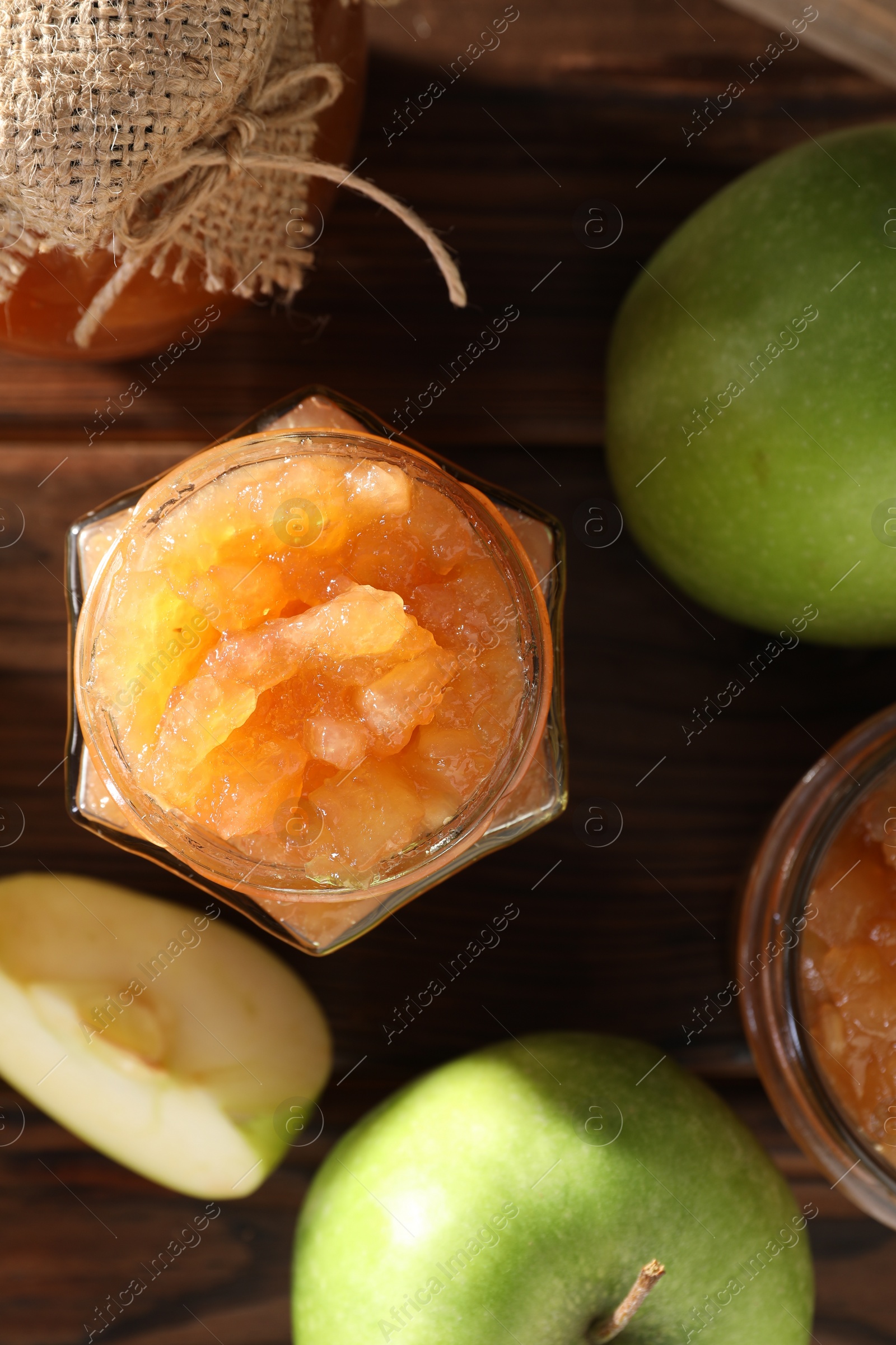 Photo of Delicious apple jam and fresh fruits on wooden, flat lay