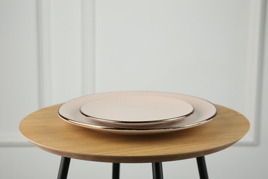 Photo of Beautiful ceramic plates on wooden table indoors, space for text