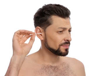 Emotional man cleaning ears and suffering from pain on white background