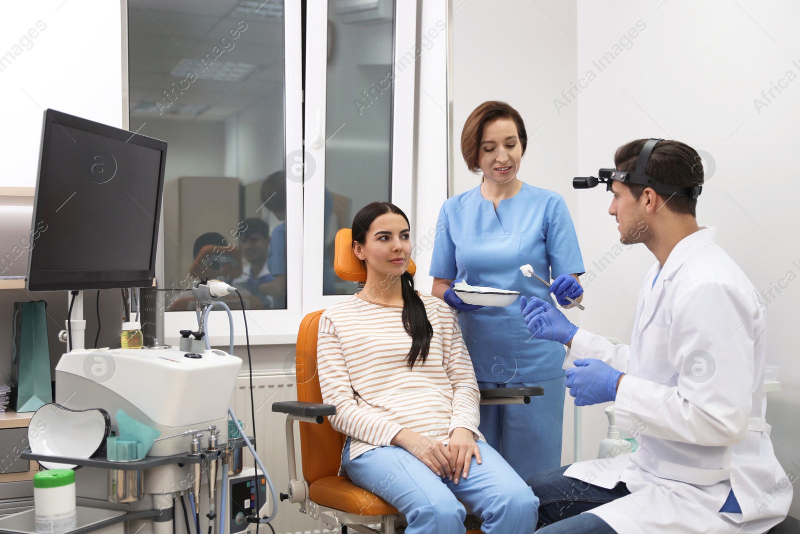 Photo of Professional doctors examining patient before surgery in clinic