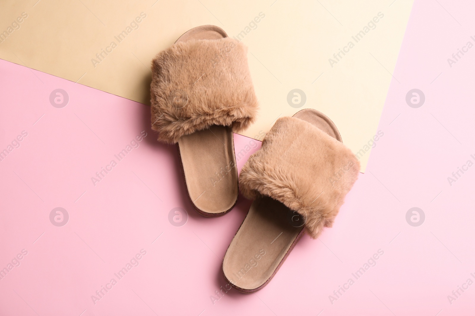 Photo of Pair of soft slippers on color background, flat lay