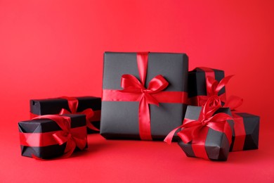 Photo of Gift boxes on red background. Black Friday sale