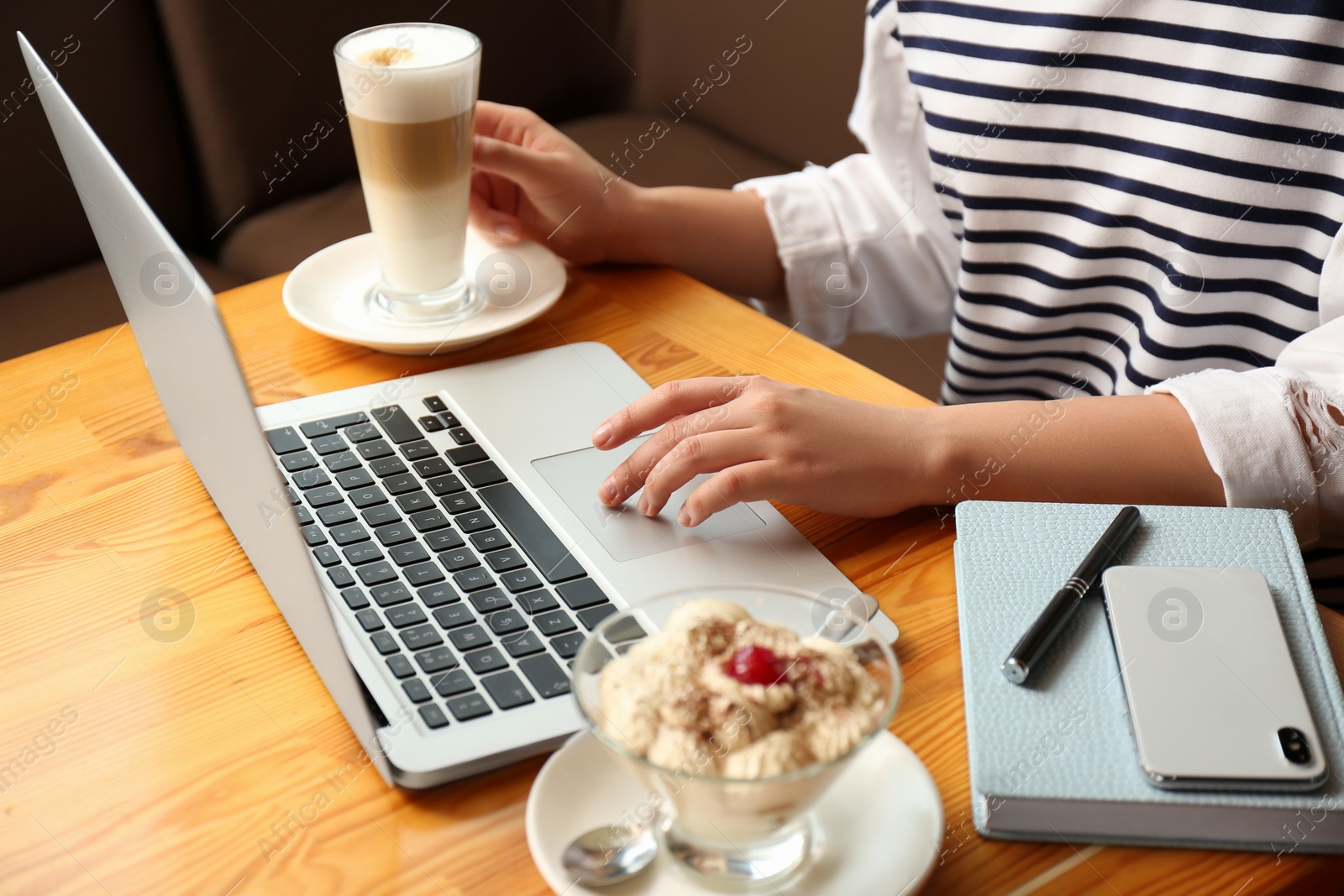 Photo of Blogger working with laptop in cafe, closeup