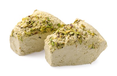 Photo of Pieces of tasty halva with pistachios on white background