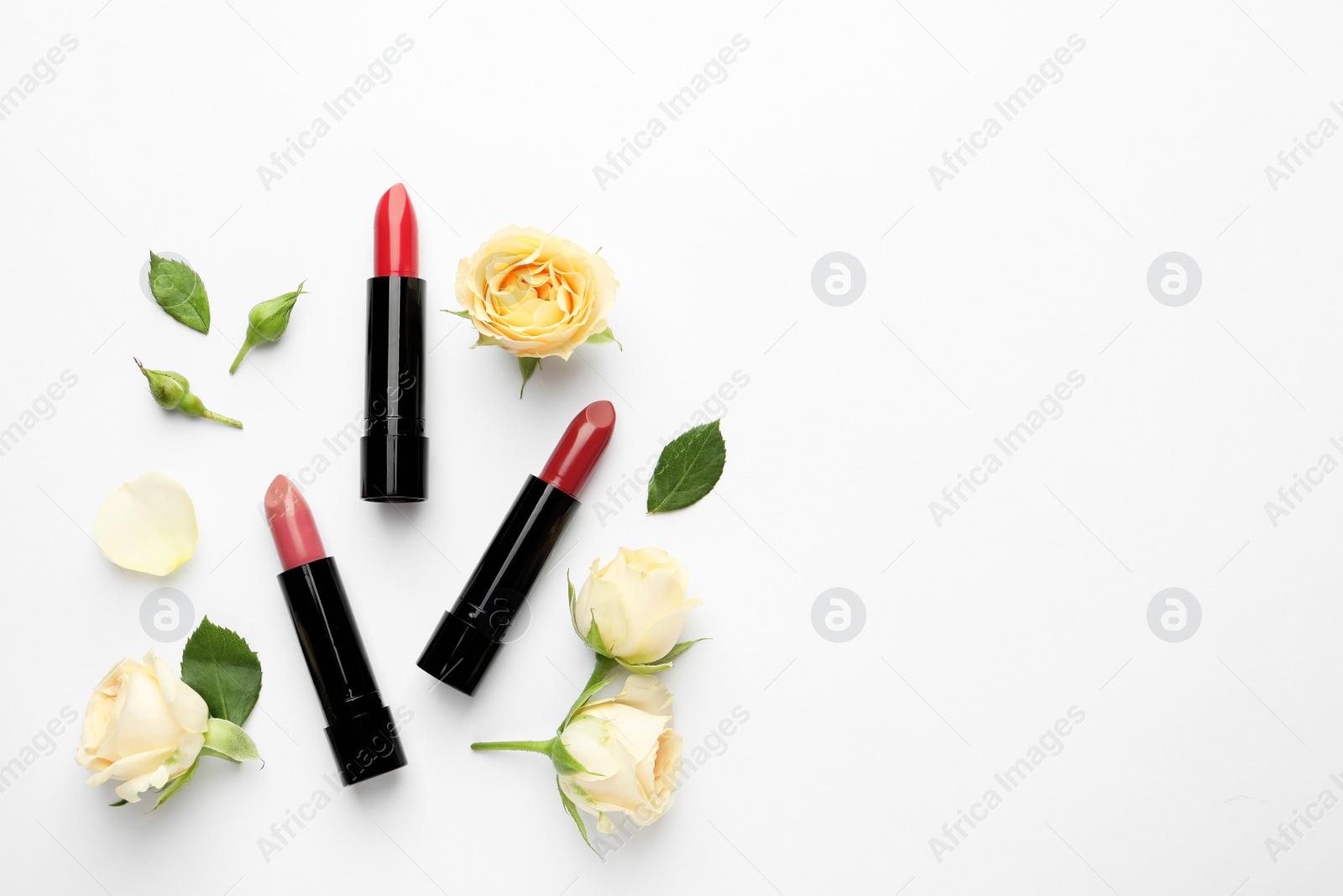 Photo of Flat lay composition with lipsticks, roses and space for text on white background