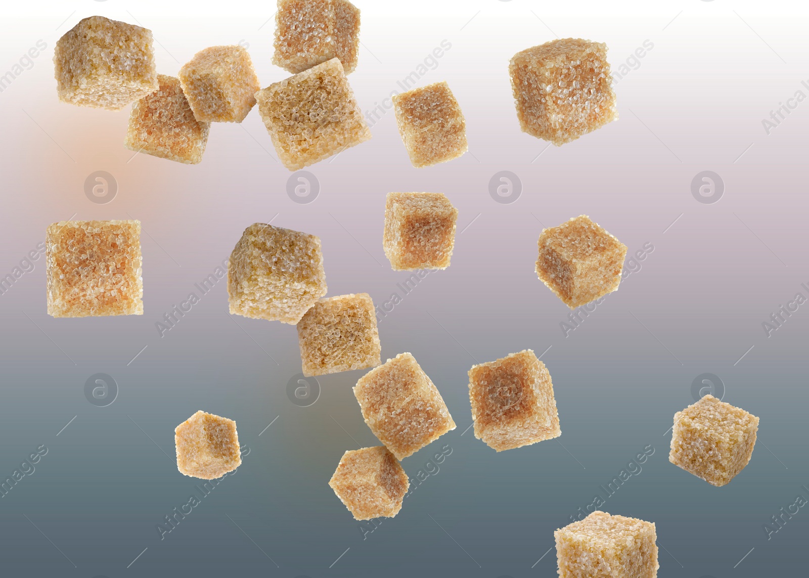 Image of Brown cane sugar cubes falling on color gradient background