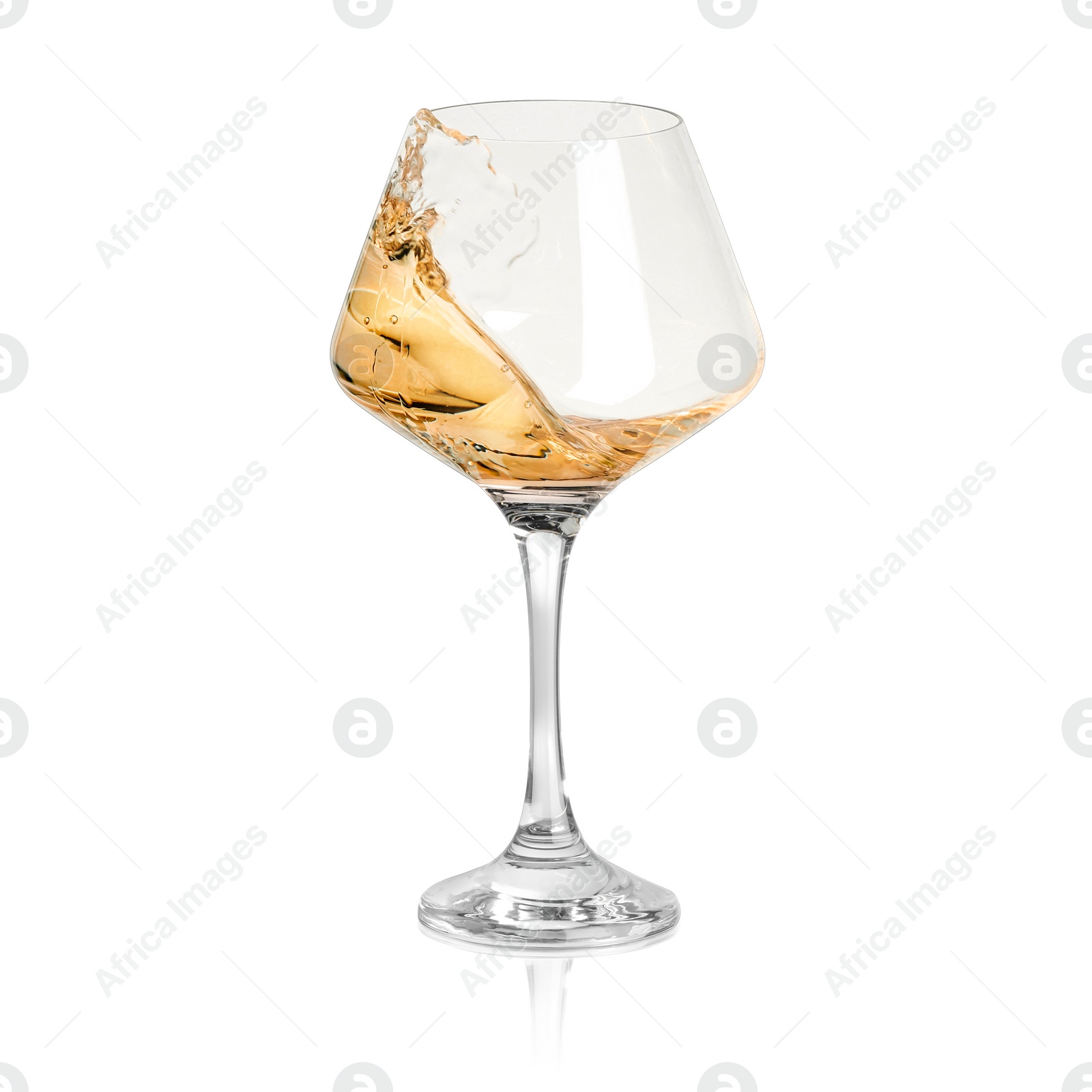 Image of White wine splashing in glass on white background