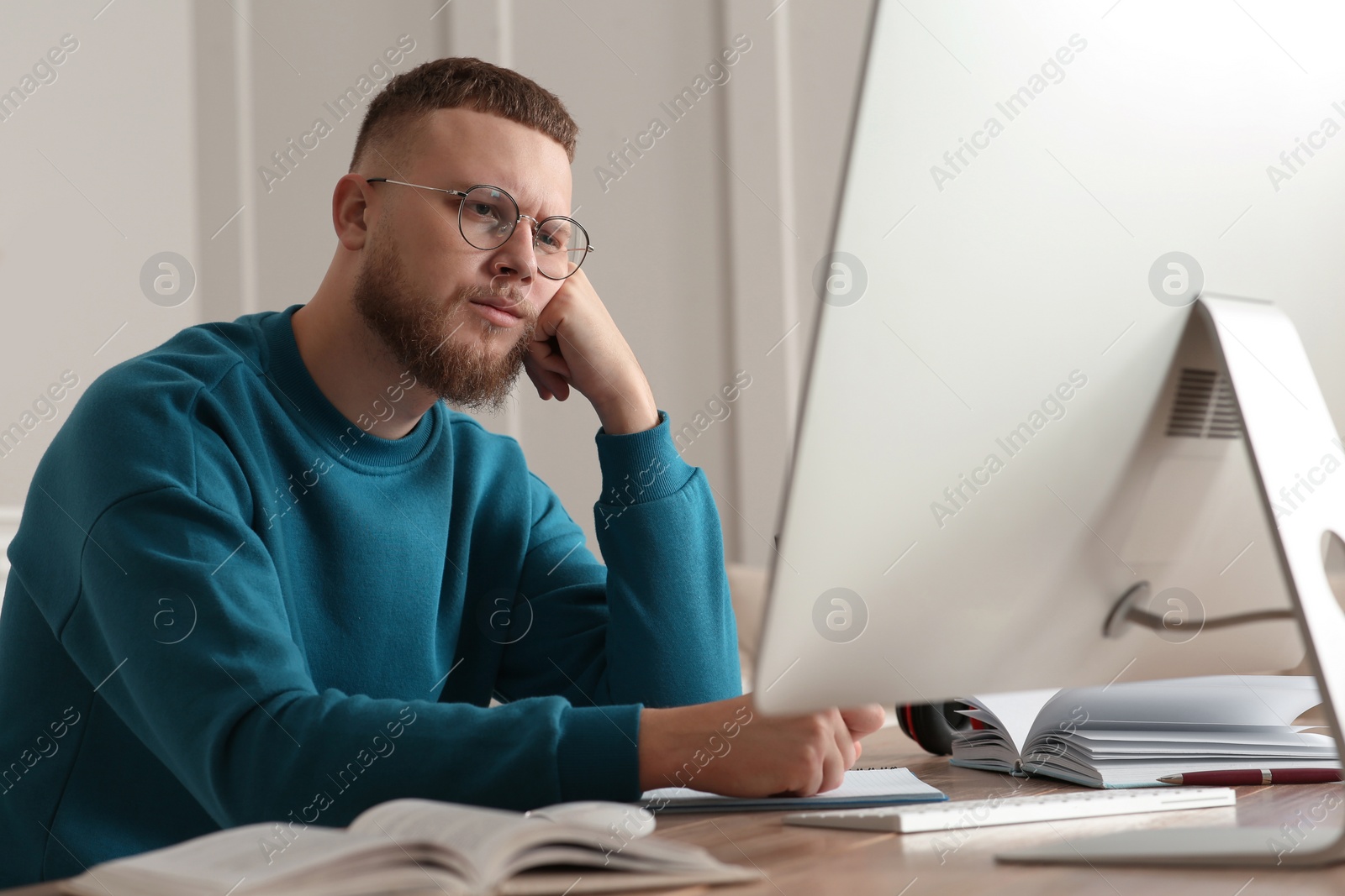 Photo of Online test. Man studying with computer at home