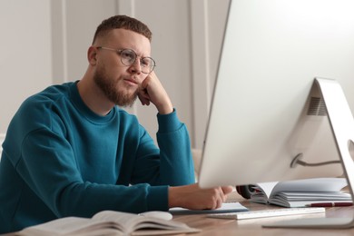 Online test. Man studying with computer at home