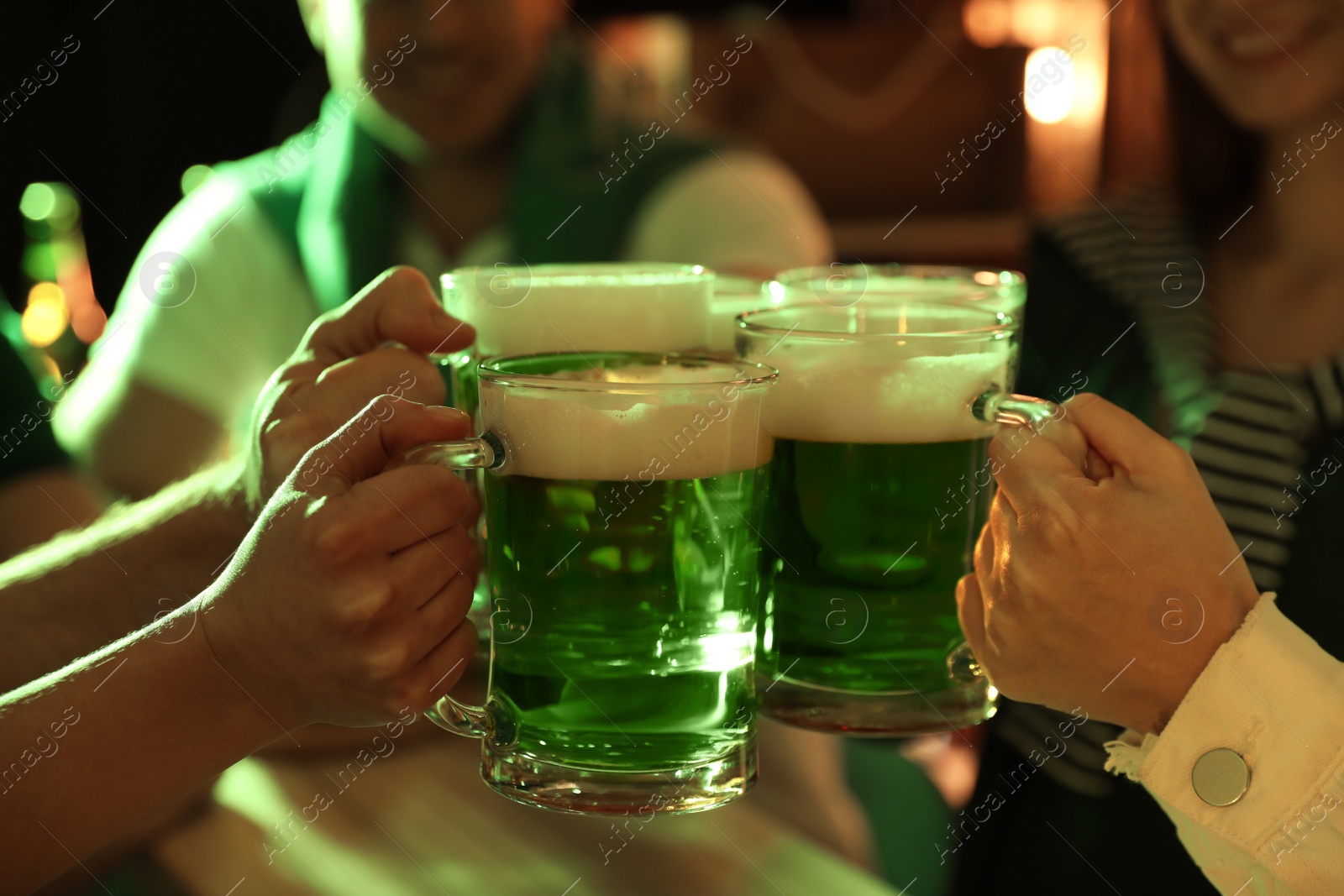 Photo of People with beer celebrating St Patrick's day in pub, closeup