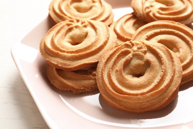 Plate with Danish butter cookies on table, closeup