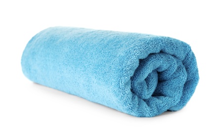 Photo of Rolled clean blue towel on white background