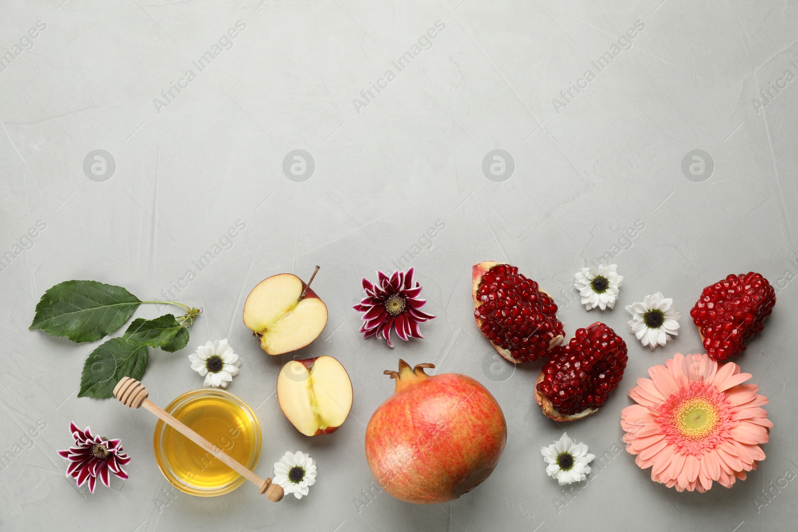 Photo of Flat lay composition with Rosh Hashanah holiday attributes on light grey background. Space for text