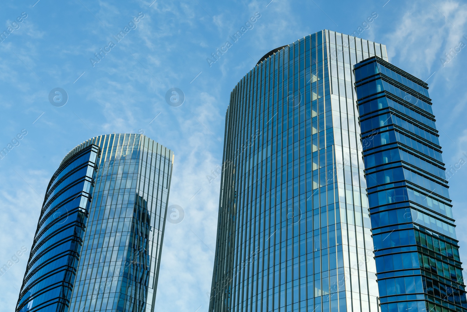 Photo of Exterior of beautiful skyscrapers against blue sky, low angle view