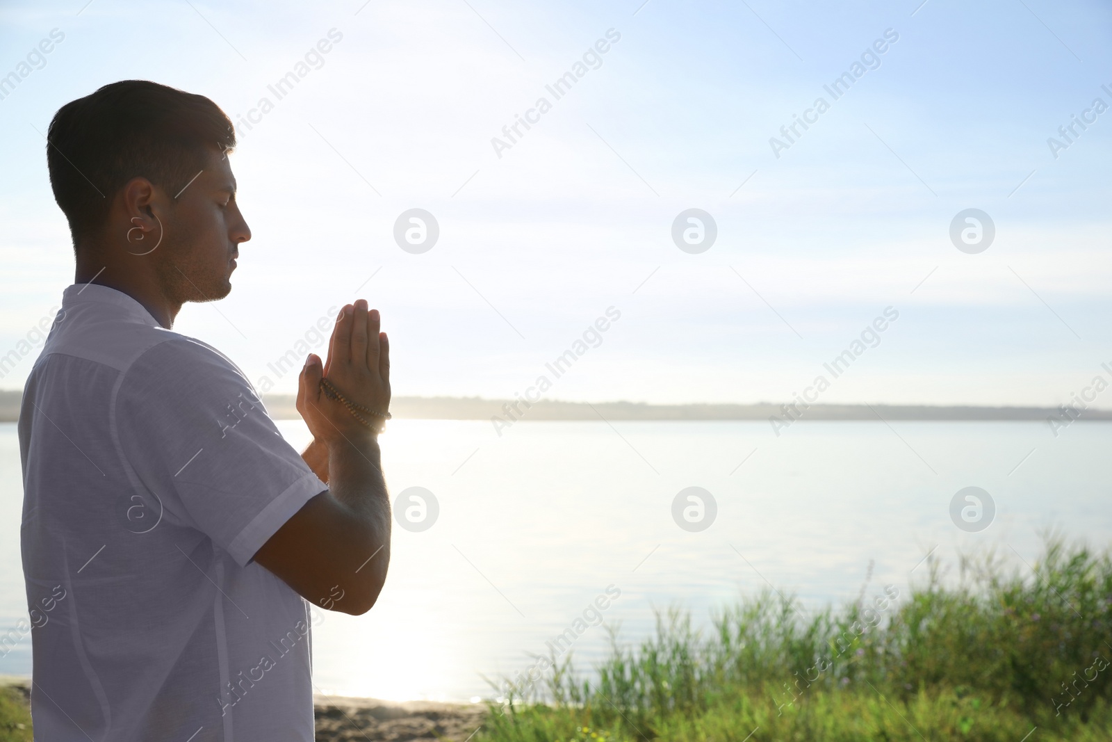 Photo of Man near river at sunset, space for text. Nature healing power