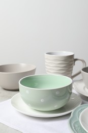 Photo of Beautiful ceramic dishware and cup on table