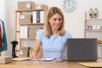 Photo of Seller with laptop working in office. Online store