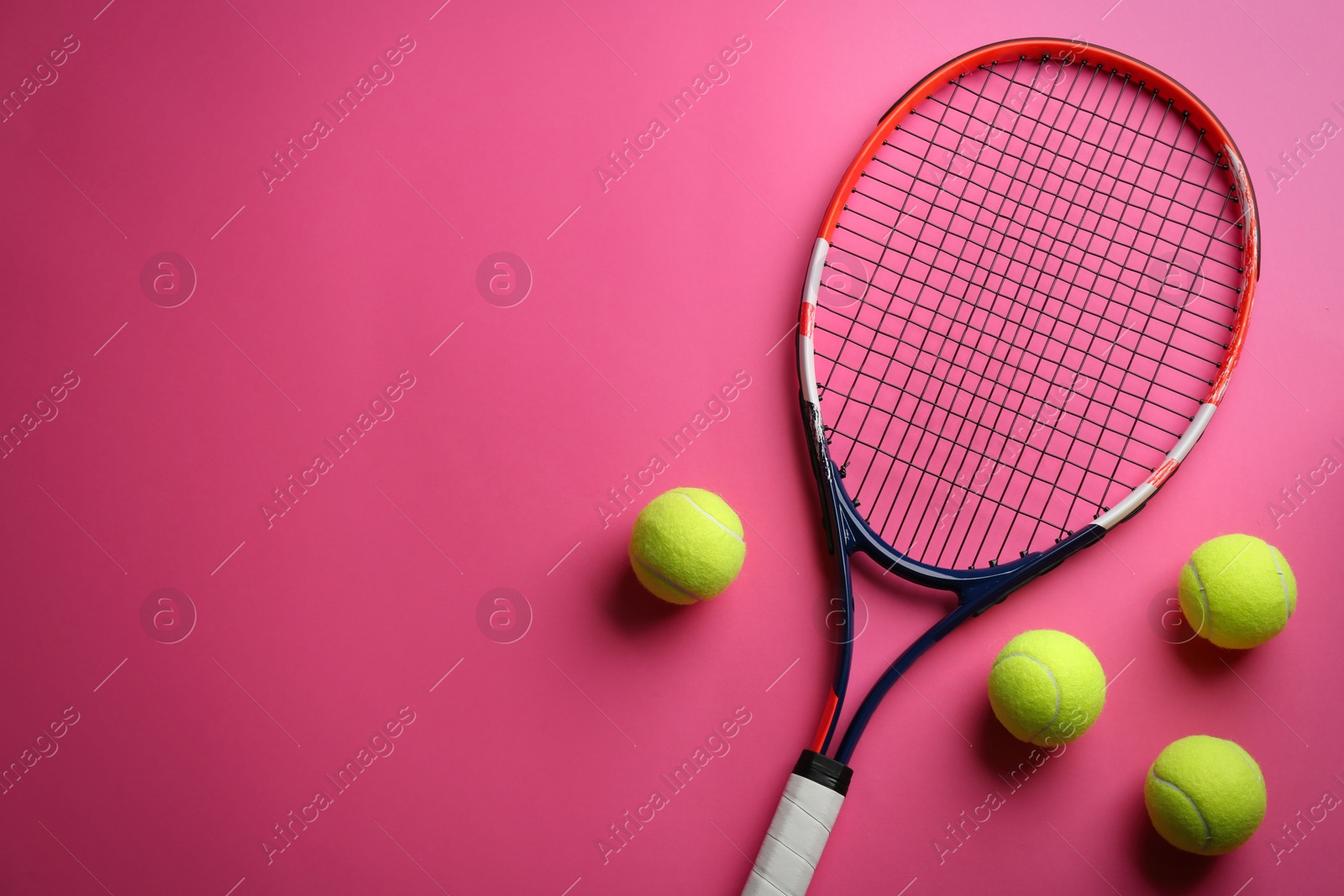 Photo of Tennis racket and balls on pink background, flat lay. Space for text