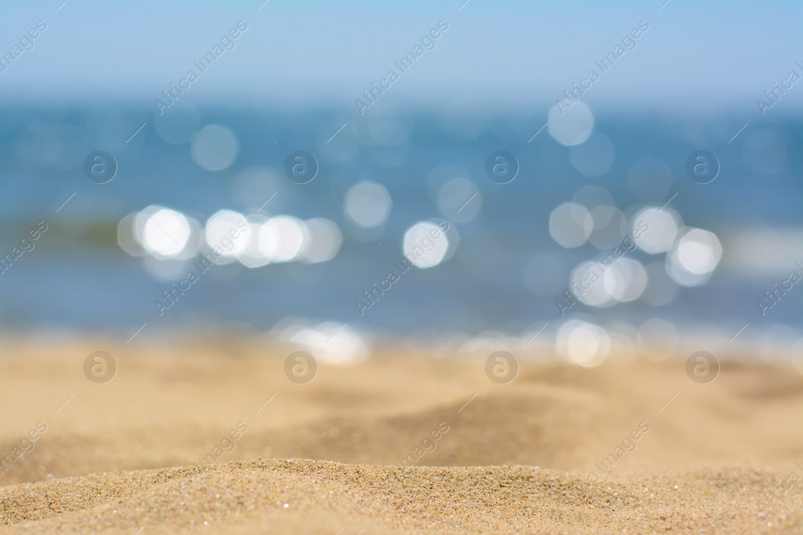 Photo of Sandy beach near sea on sunny day, closeup view