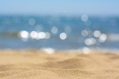 Photo of Sandy beach near sea on sunny day, closeup view