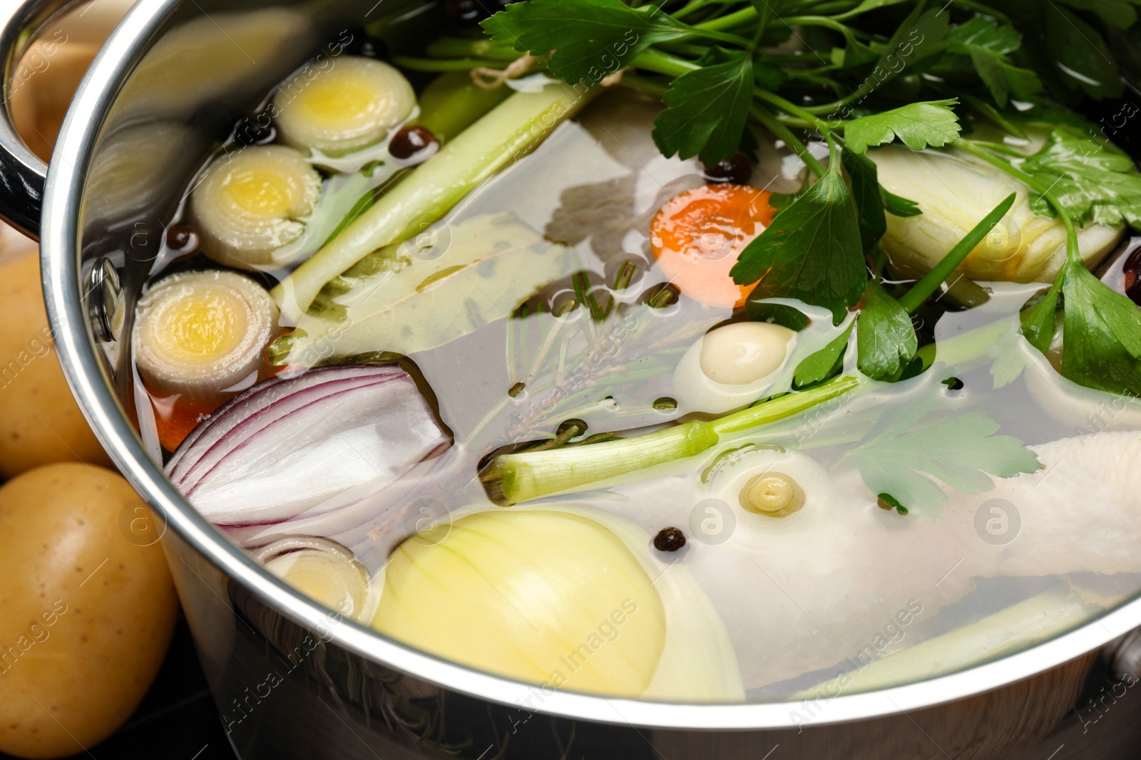 Photo of Pot with different ingredients for cooking tasty bouillon, closeup