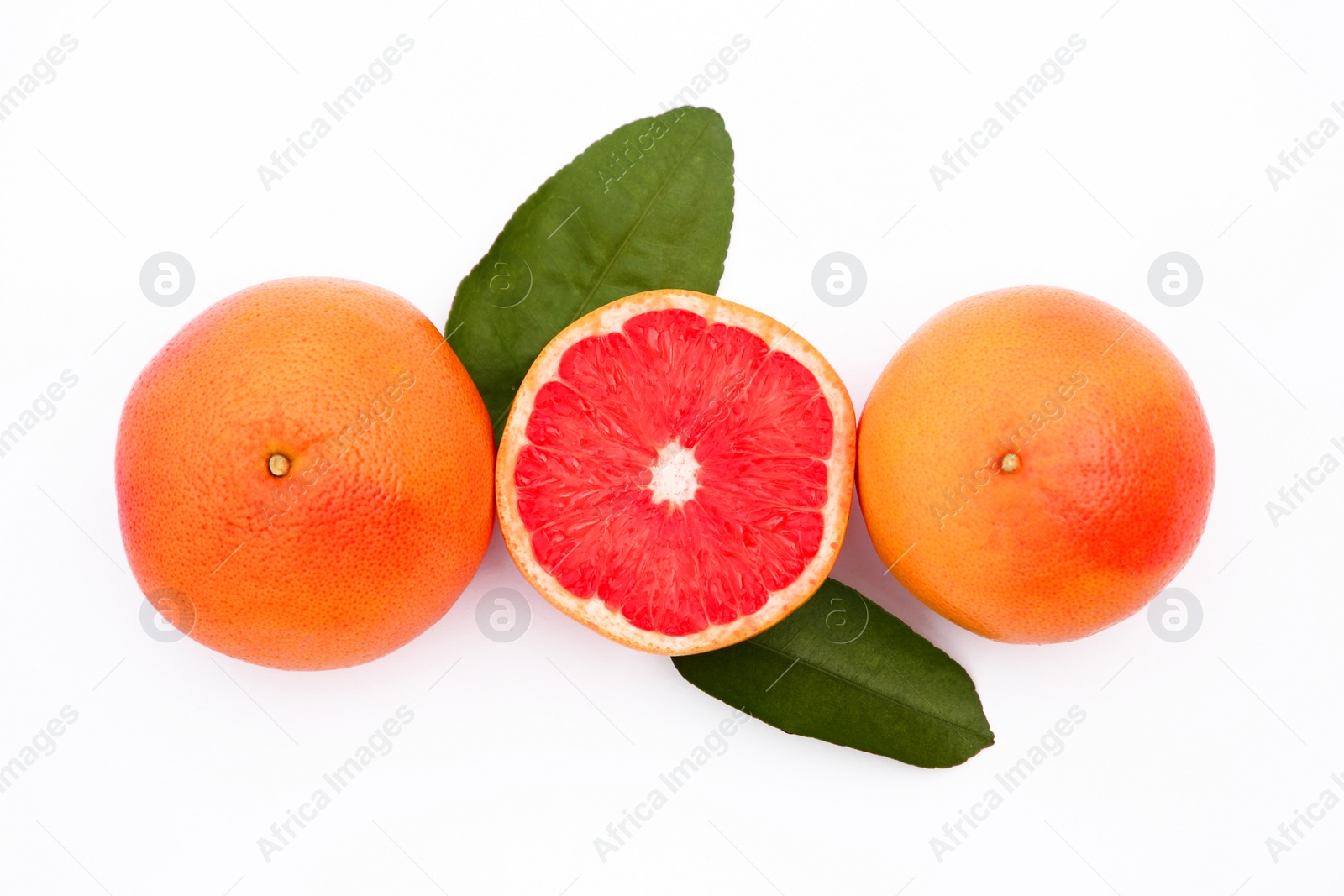 Photo of Fresh grapefruits and green leaves on white background, flat lay