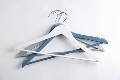 Photo of Empty clothes hangers on white background, top view