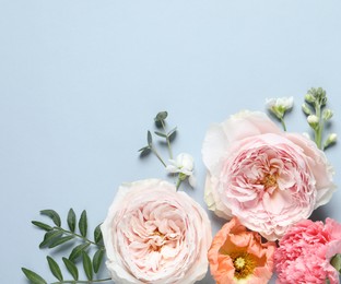 Photo of FLat lay composition with different beautiful flowers on light grey background. Space for text
