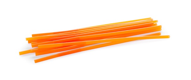 Orange plastic cocktail straws on white background