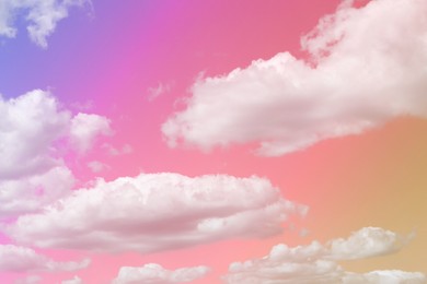 Magic sky with fluffy clouds toned in bright rainbow colors