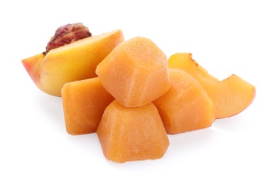 Photo of Frozen nectarine puree cubes and ingredients on white background