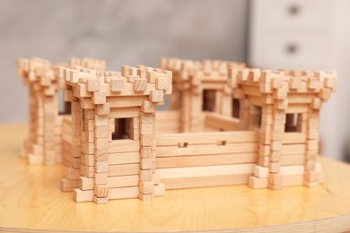 Wooden fortress on table indoors, closeup. Children's toy