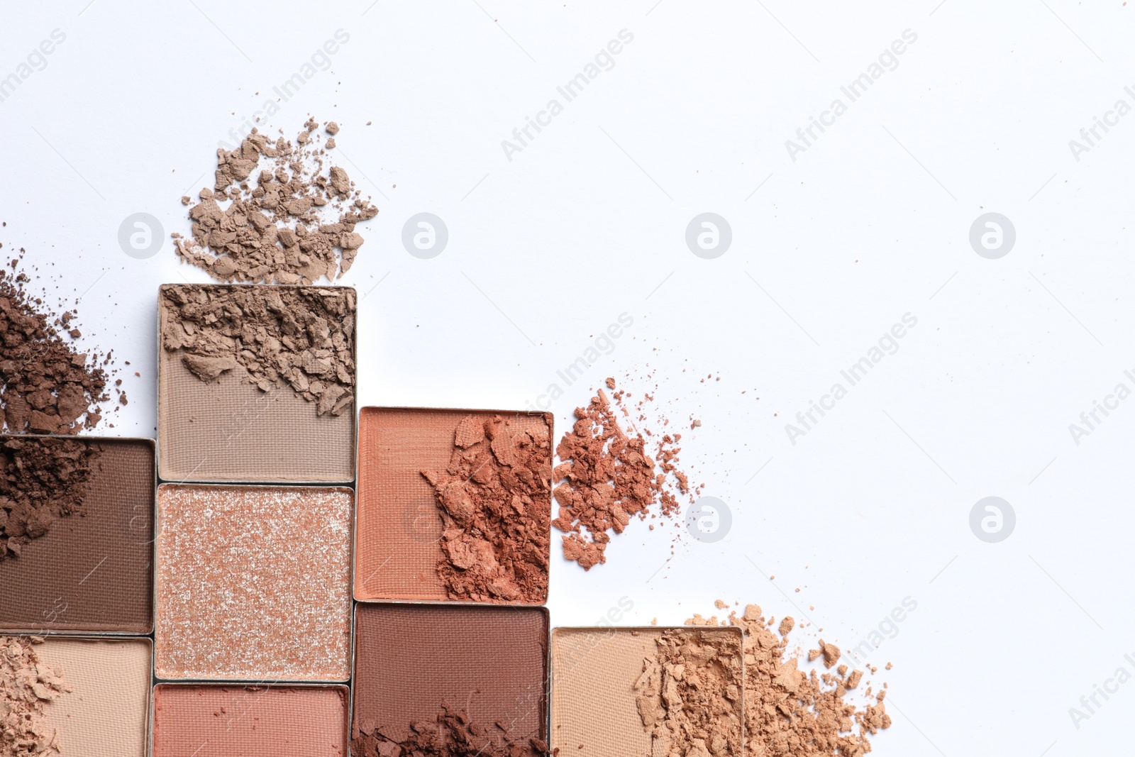 Photo of Crushed eye shadows on white background, flat lay with space for text. Professional makeup product