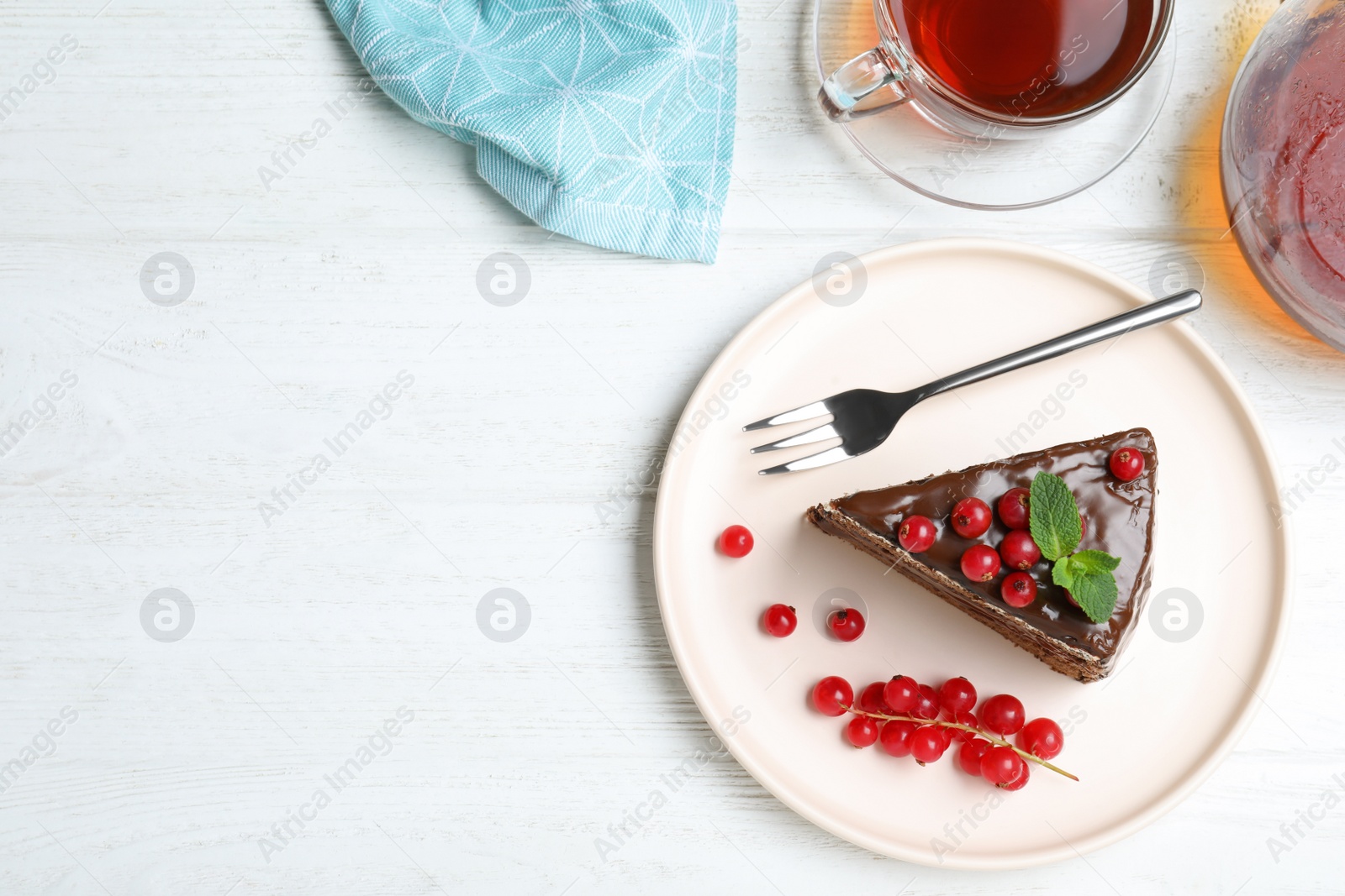 Photo of Delicious chocolate cake with red currants on white wooden table, flat lay. Space for text