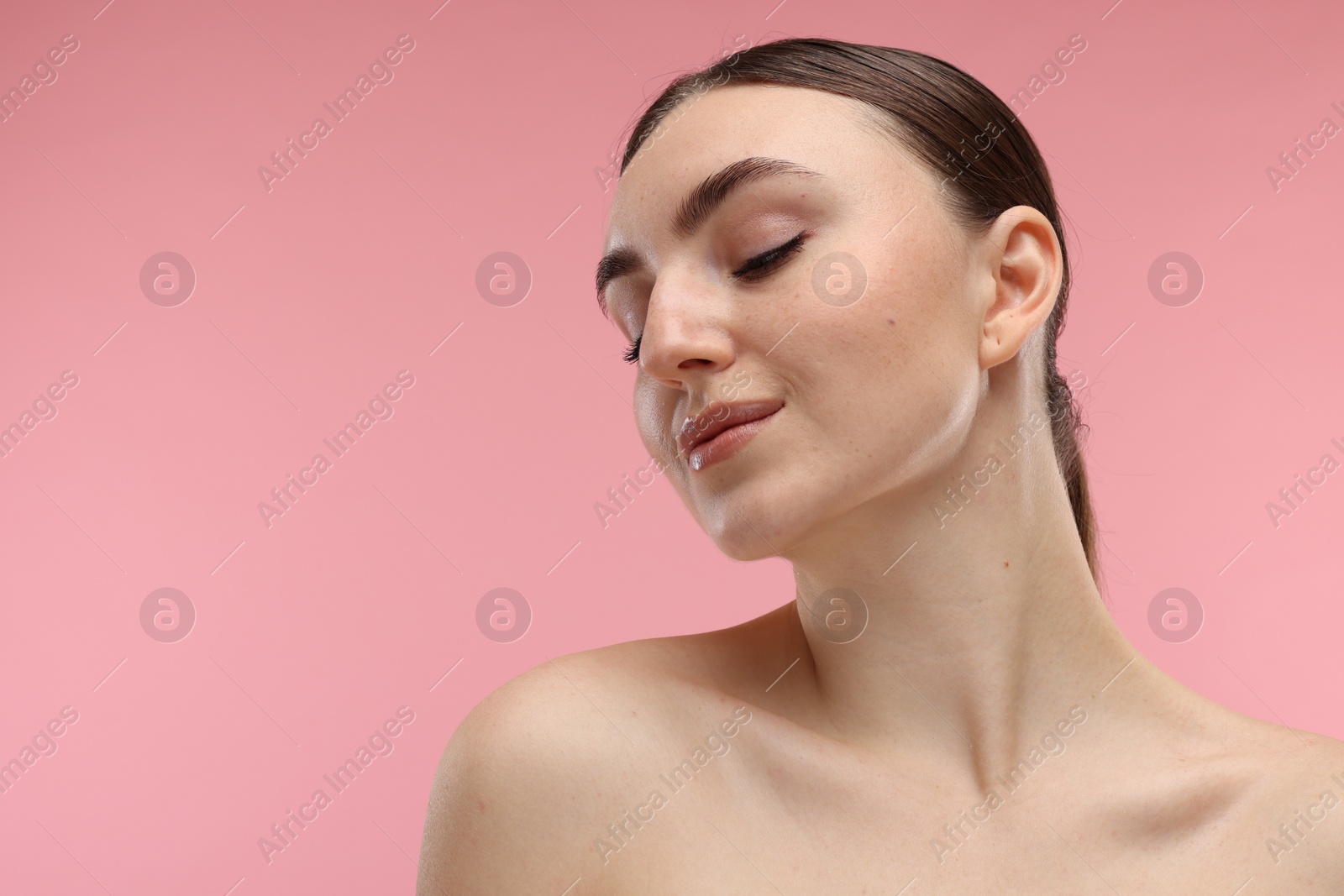 Photo of Portrait of beautiful woman on pink background. Space for text