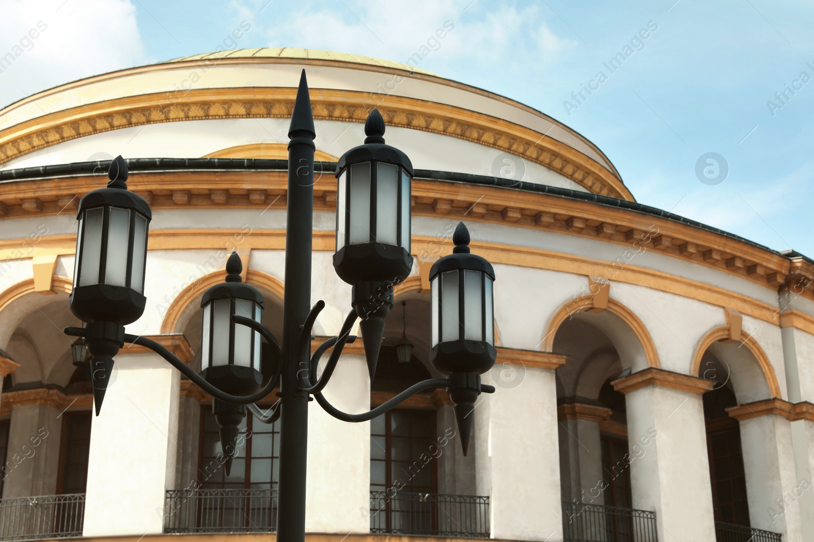 Photo of Old fashioned street light lamp near beautiful building