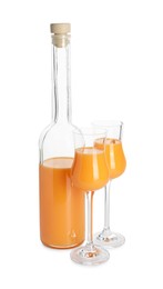 Bottle and glasses with tasty tangerine liqueur isolated on white