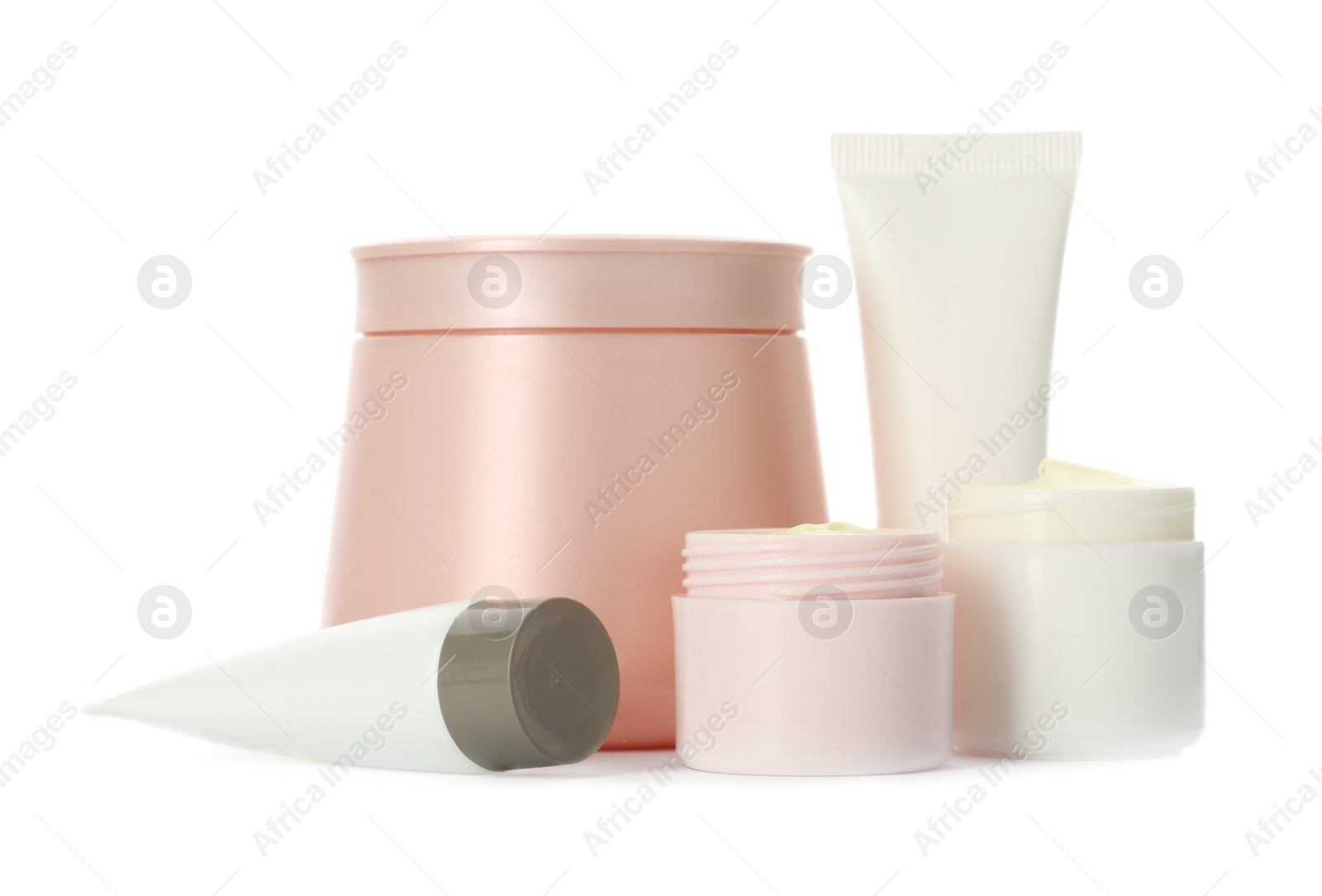 Photo of Different containers with hand cream and other cosmetic on white background