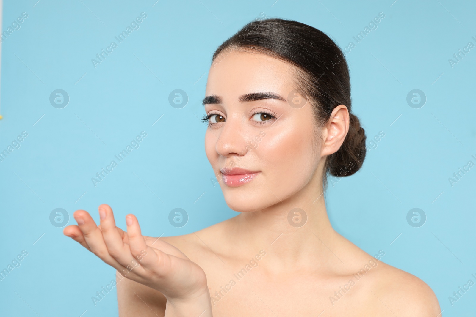 Photo of Portrait of young woman with beautiful face against color background