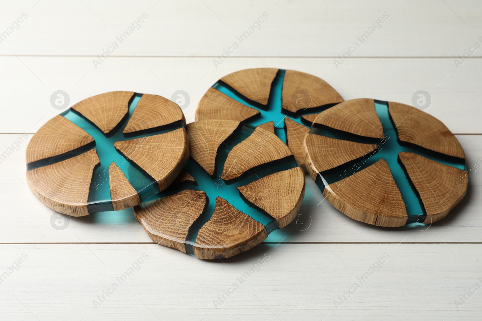 Photo of Stylish wooden cup coasters on white table