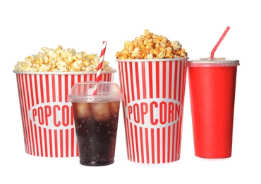 Photo of Delicious fresh popcorn and cups with beverages on white background