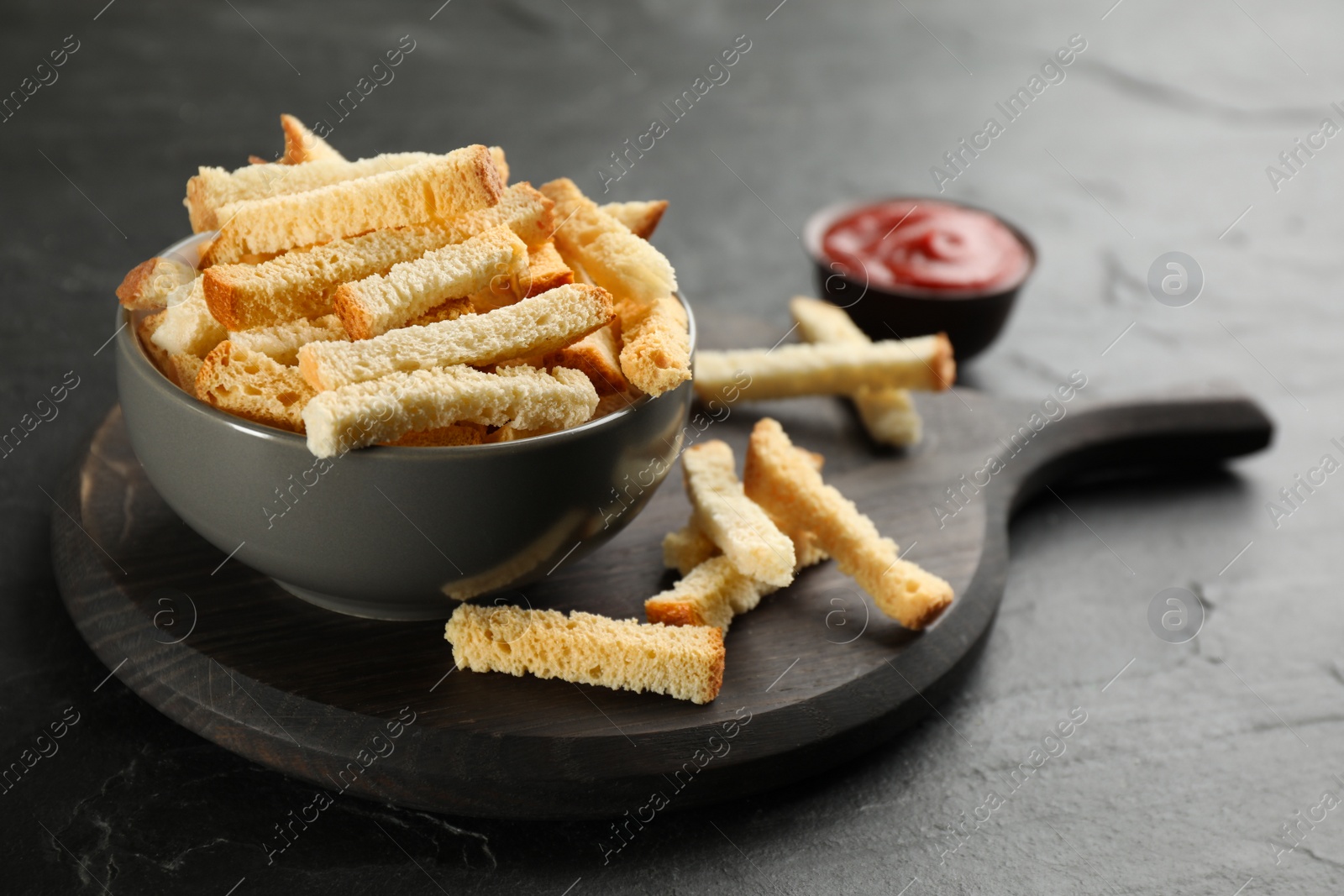 Photo of Delicious hard chucks in bowl on black table