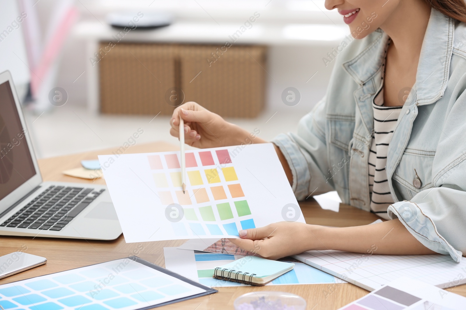 Photo of Professional interior designer with color palette at workplace in office, closeup