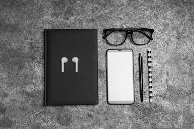 Photo of Flat lay composition with notebook and smartphone on grey background