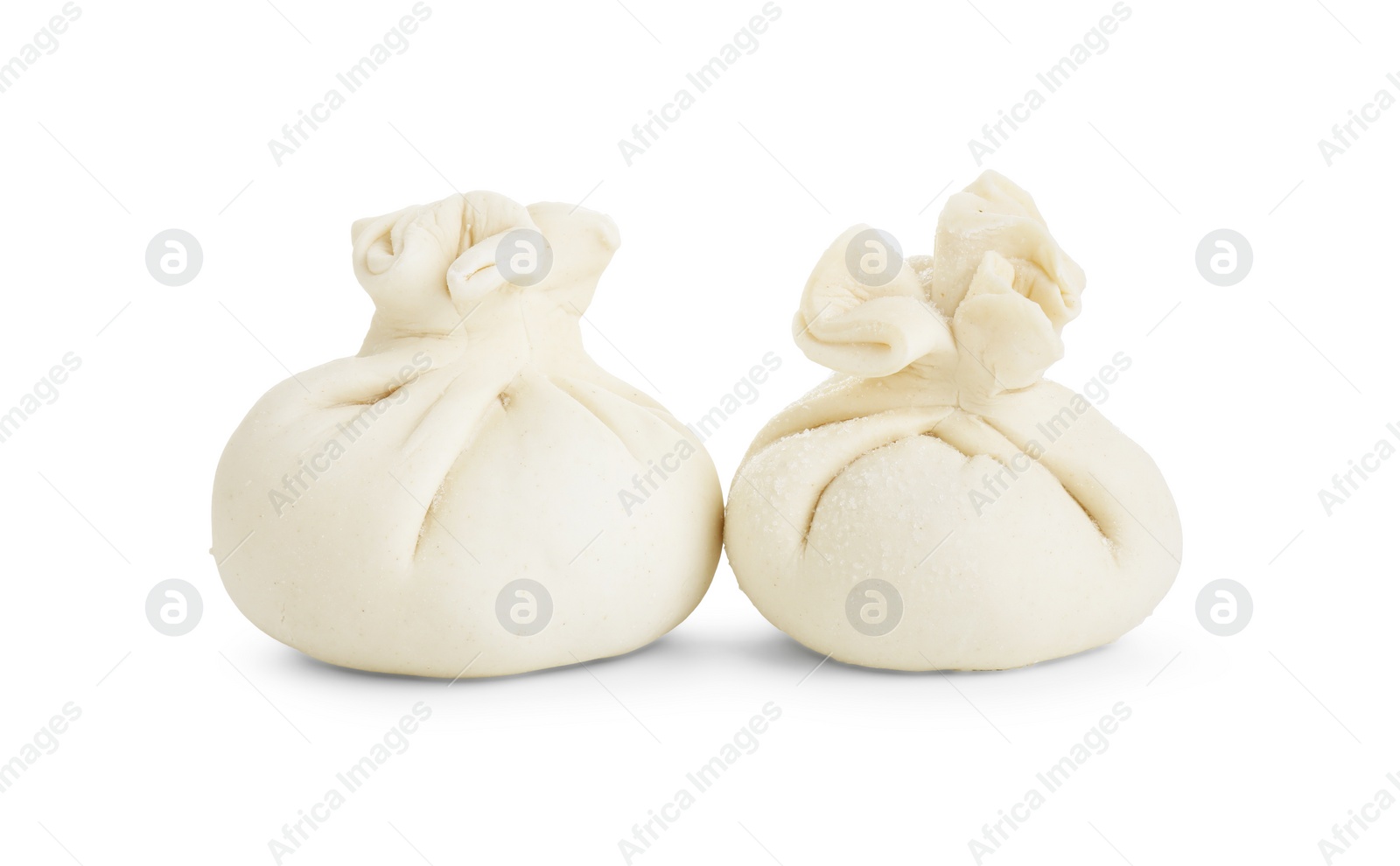 Photo of Uncooked khinkali (dumplings) isolated on white. Georgian cuisine