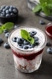 Delicious chia pudding with blueberries on grey table