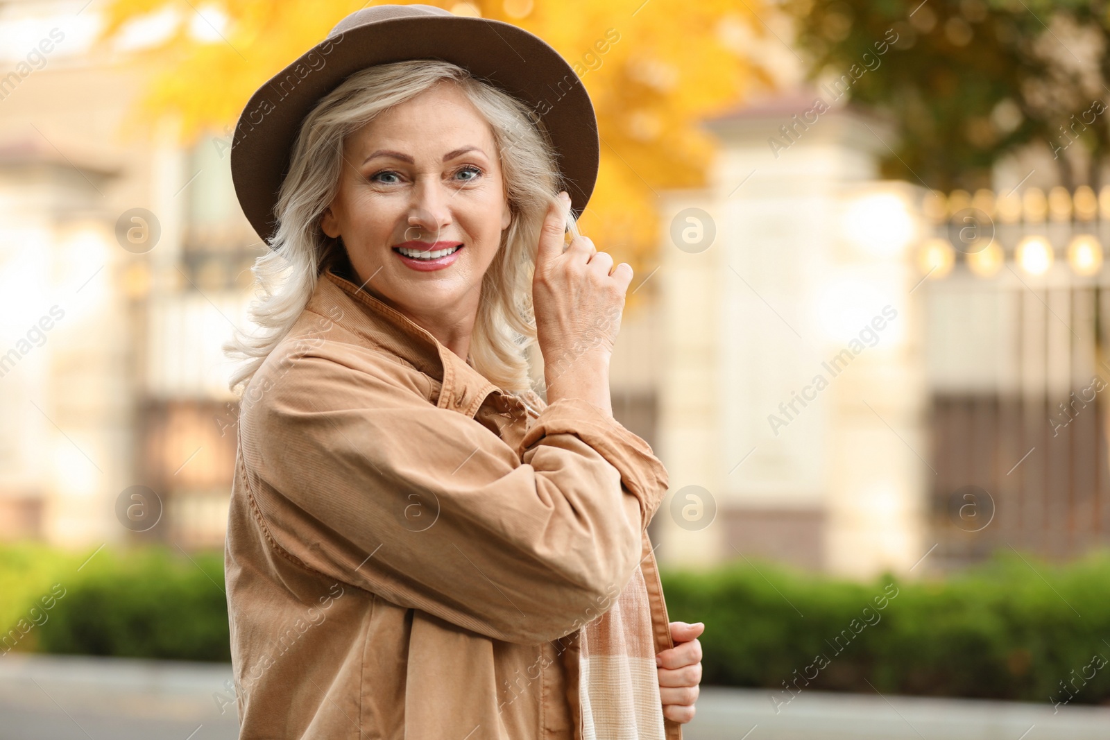 Photo of Portrait of happy mature woman with hat outdoors