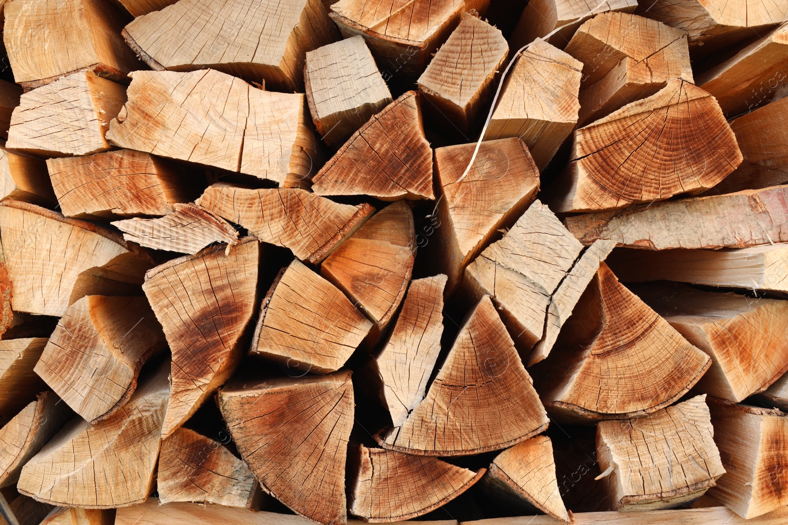 Photo of Stack of chopped firewood as background, closeup