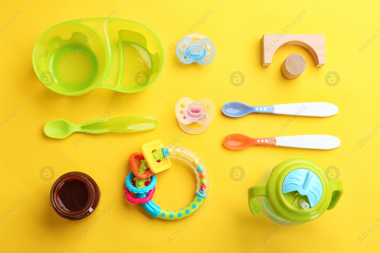 Photo of Flat lay composition with baby food and accessories on color background