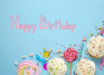 Image of Flat lay composition with delicious cupcakes and text Happy Birthday on light blue background